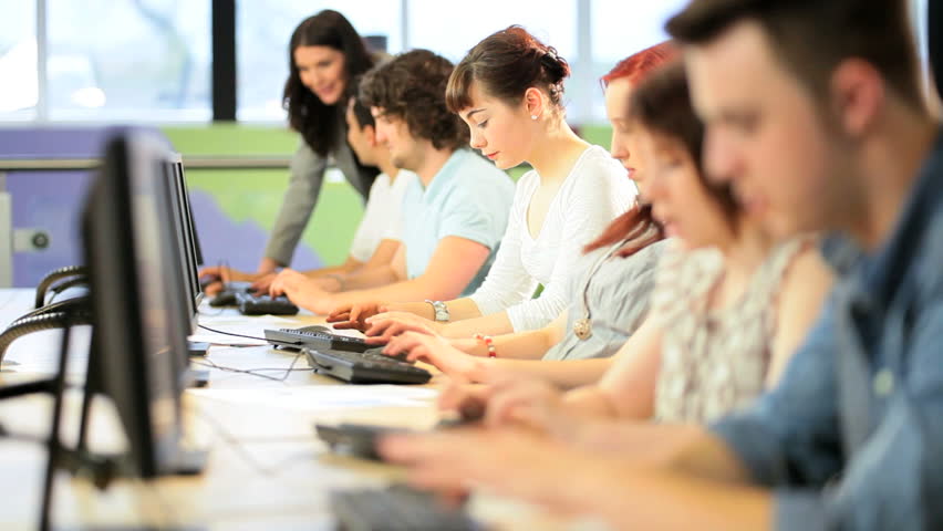 Caucasian Female Teacher And Multi Ethnic Students Using Computers Online Education In