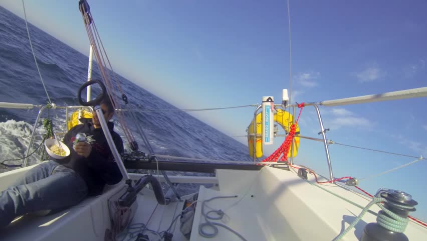 Single Handed Ocean Sailor Enjoying A Meal On The Leeward Side Of His 