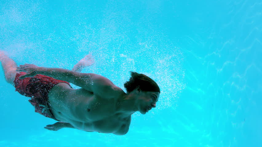 Fit Man Swimming Underwater In The Pool In Slow Motion Stock Footage