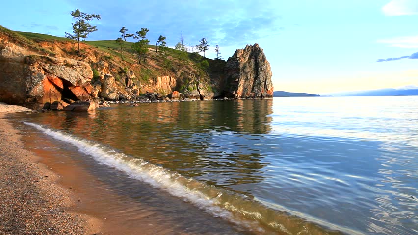 Waves On The Sandy Shores Of Lake Baikal At Sunset In Summer Stock