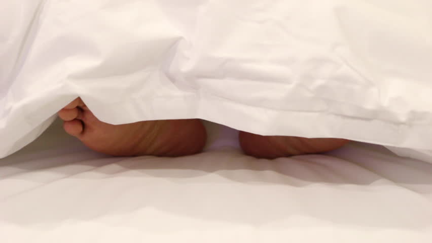 Playing Foot Under The Covers At Home In Bed Stock Footage Video