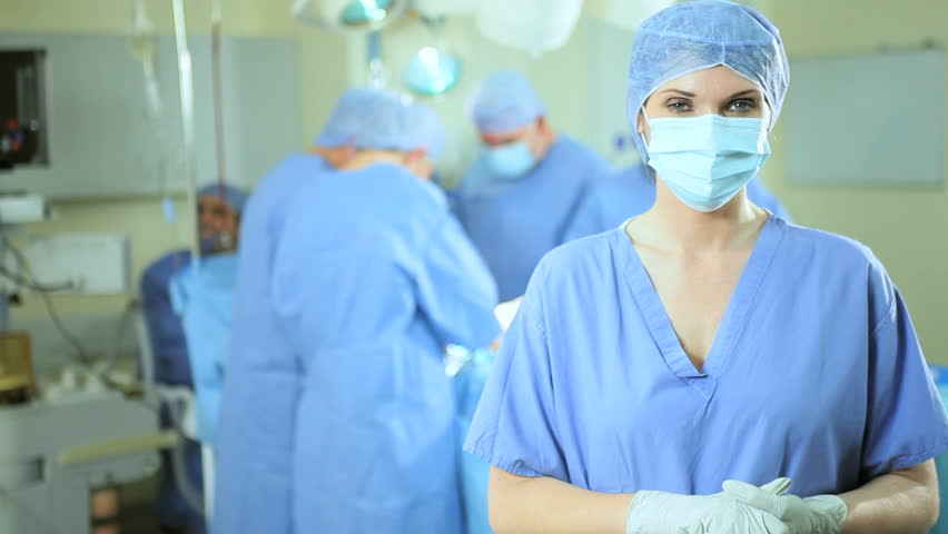 Portrait Female Caucasian Nurse Wearing Full Surgical Scrubs With Team ...