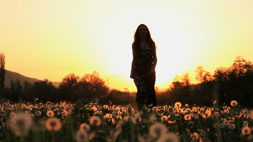 Beautiful Young Woman In A Hippy Dress Running Down A Dandelion Field ...