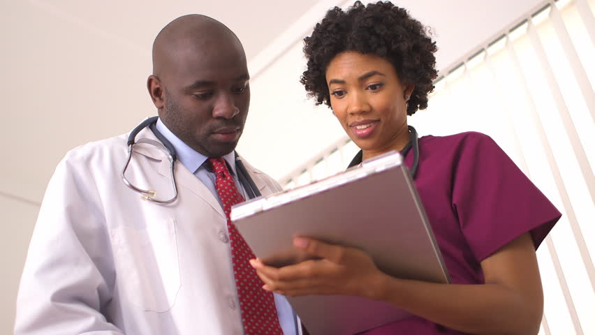 African American Medical Professionals Reviewing Medical Charts Stock ...