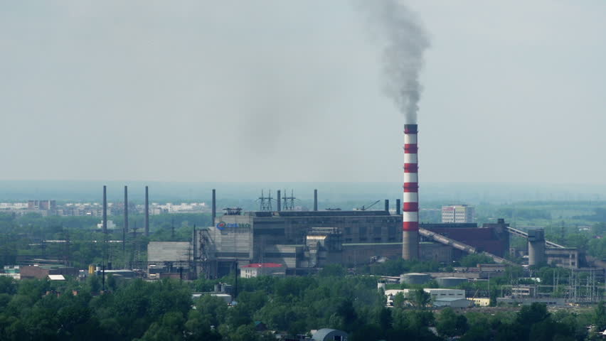 Fumes Billow Out Of A Giant Smoke Stack Against A Blue Sky. (High ...