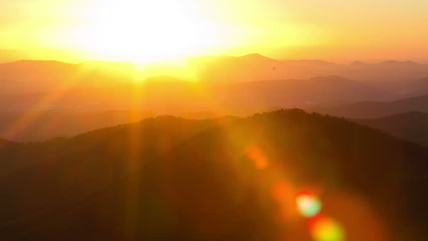 Time Lapse Of The Sun Rising From Behind Mountains. Tight Shot With A ...